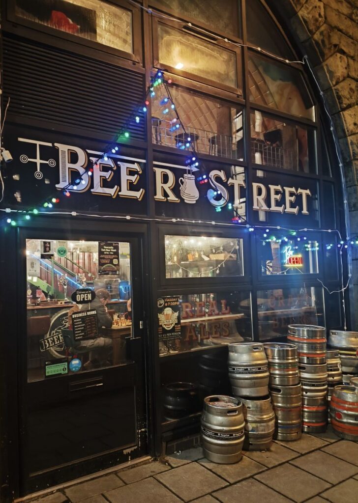 Beer Street Exterior in Newcastle at dusk with barrels stacked outside