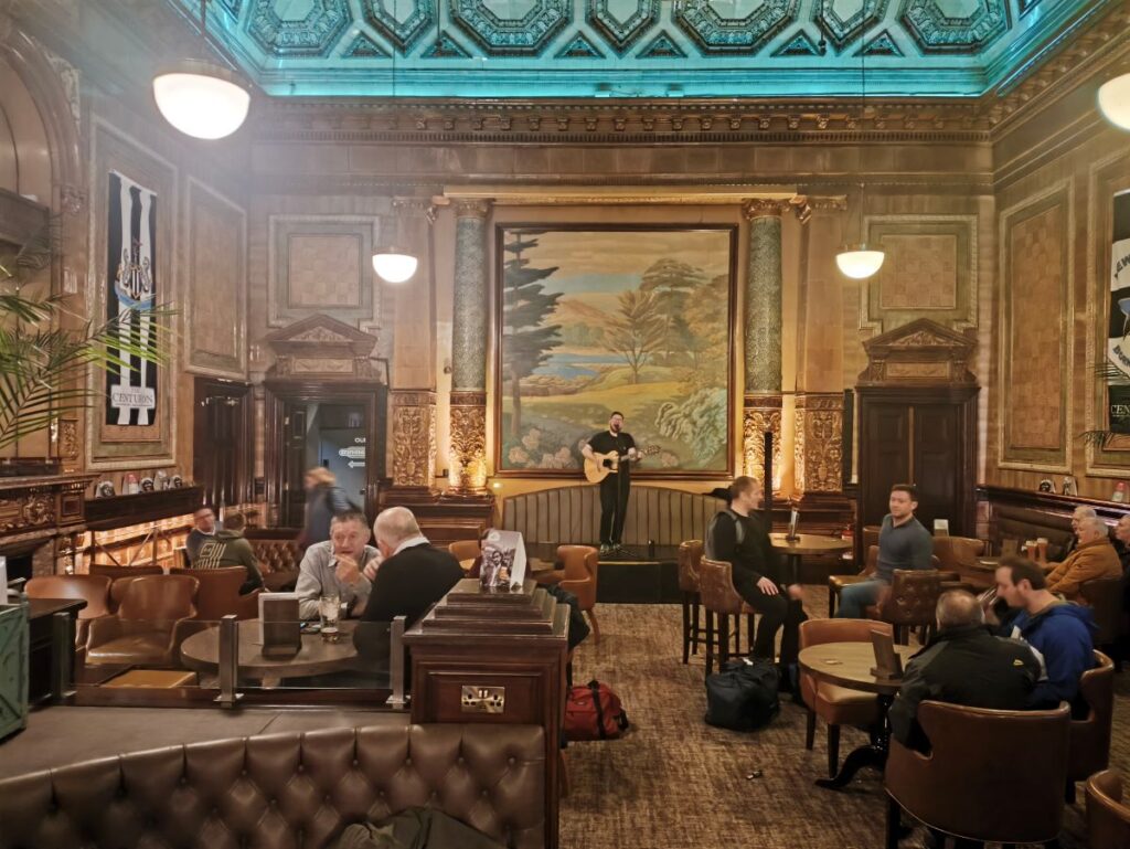 The Centurion Bar at Newcastle Central Railway Station showing a singer/guitarist under the tiled walls
