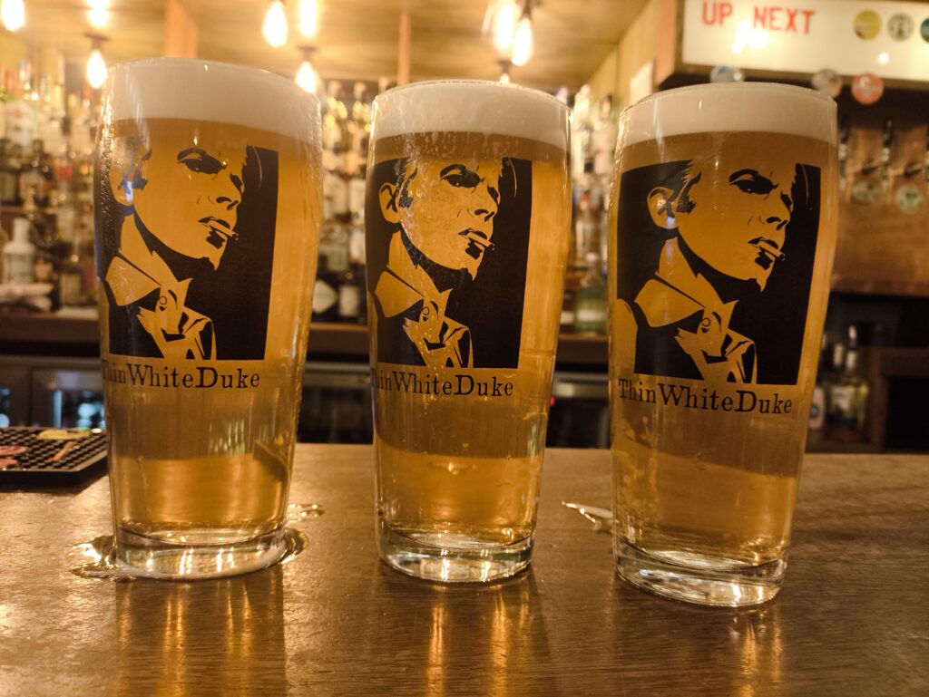 Three pints of real ale in branded glasses on the bar of the Thin White Duke in Carlisle