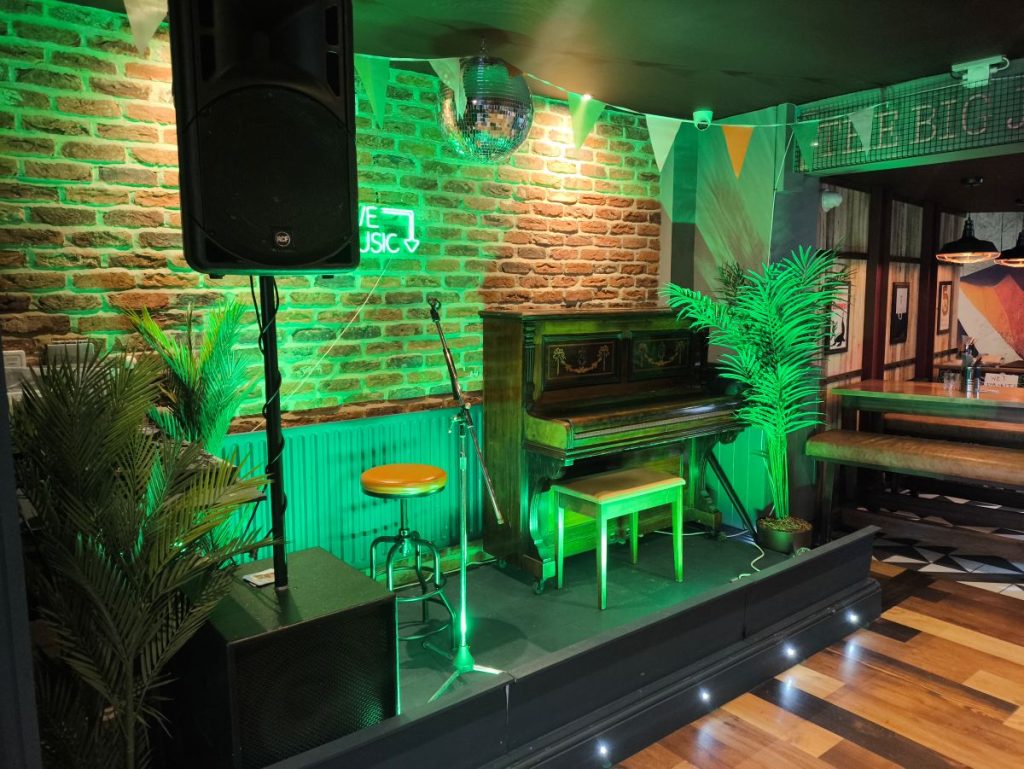 Interior view of Mr Flynn's Pub, formerly The Big Jug showing stage, piano and speaker