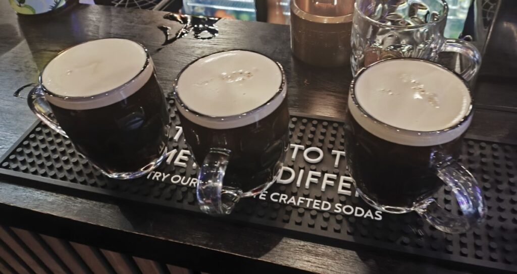 Three pots of Guinness on the bar of Stanley's Pub in Carlisle