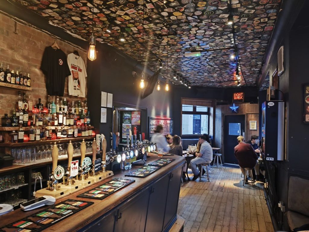 Interior of the Trent House Pub in Newcastle showing the bar with ale pumps along with blue star and other memorabilia