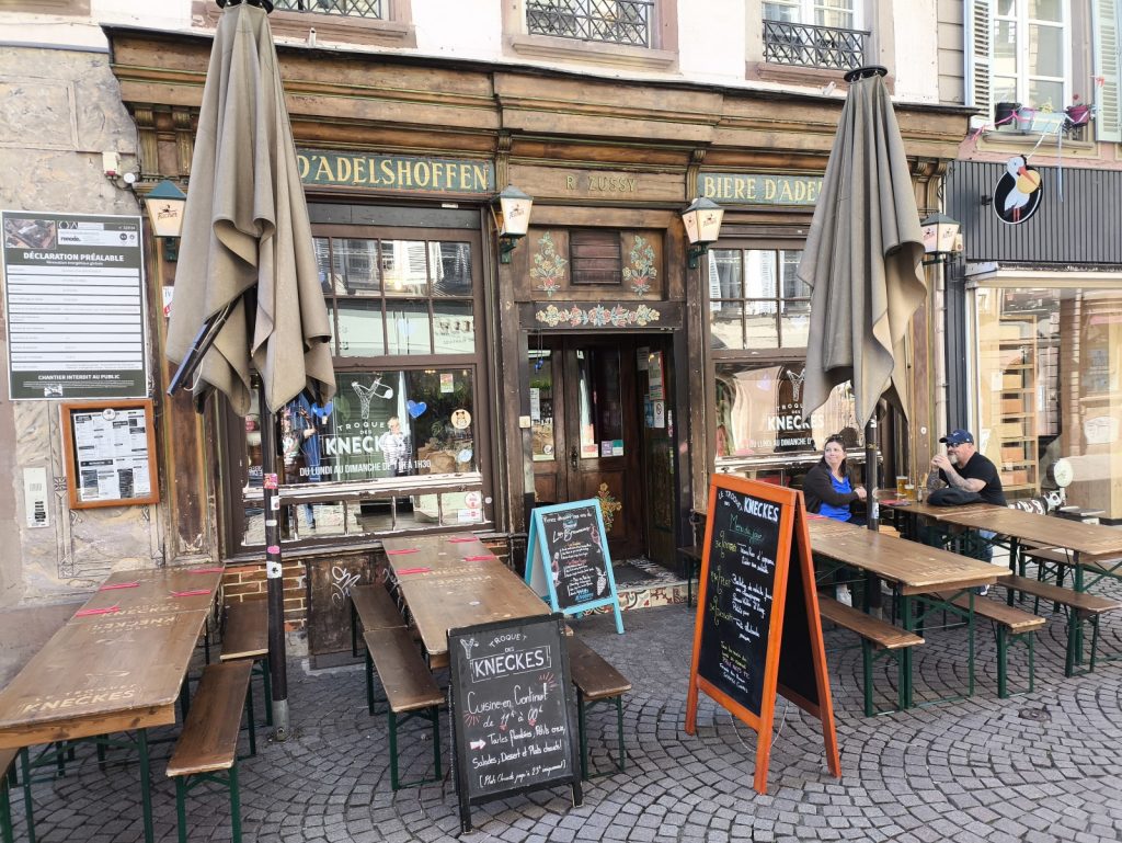 Exterior of Le Troquet des Kneckes in Strasbourg France with external seating and umbrellas