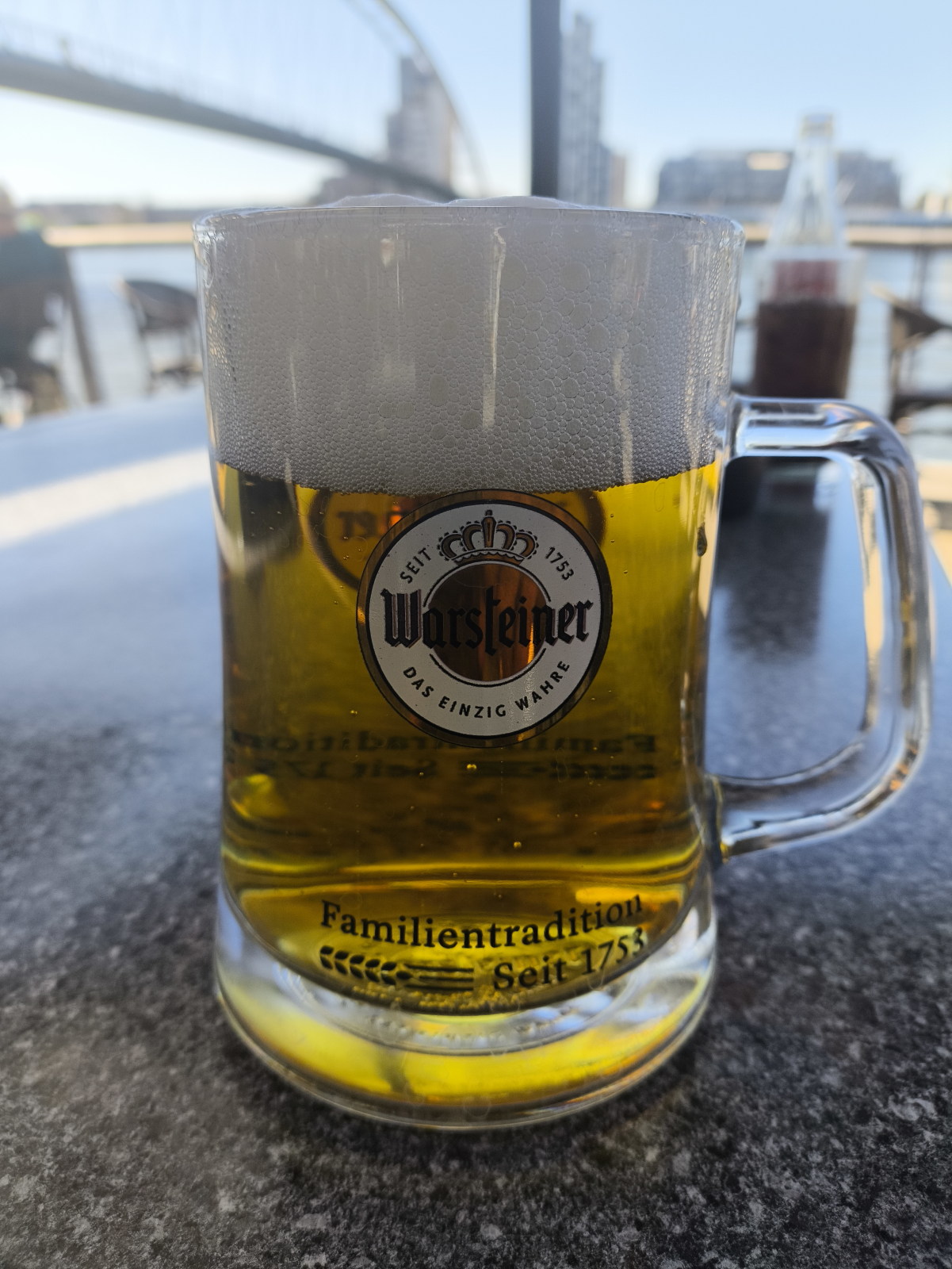 A cold Warsteiner beer on an outside table