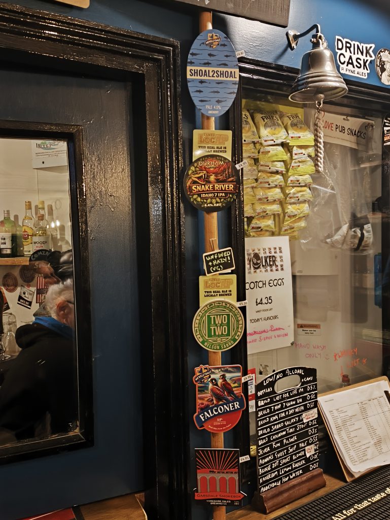 Cask ales pump clips at the servery of The Station House Pub in Durham City.