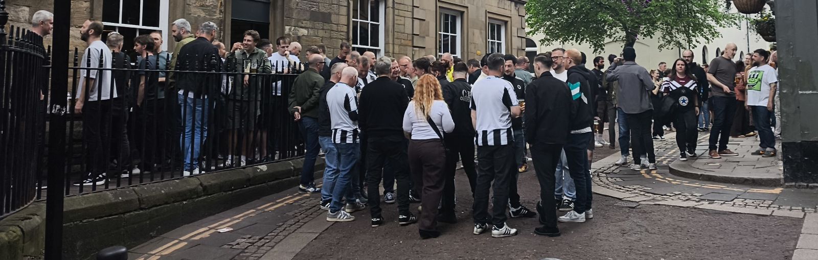 Football fans enjoying refreshments on Pink Lane Newcastle before the game