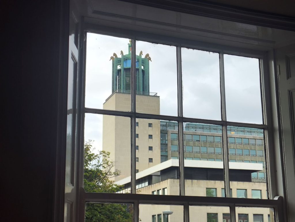 Newcastle Civic Centre through a window of the Five Swans Wetherspoons pub