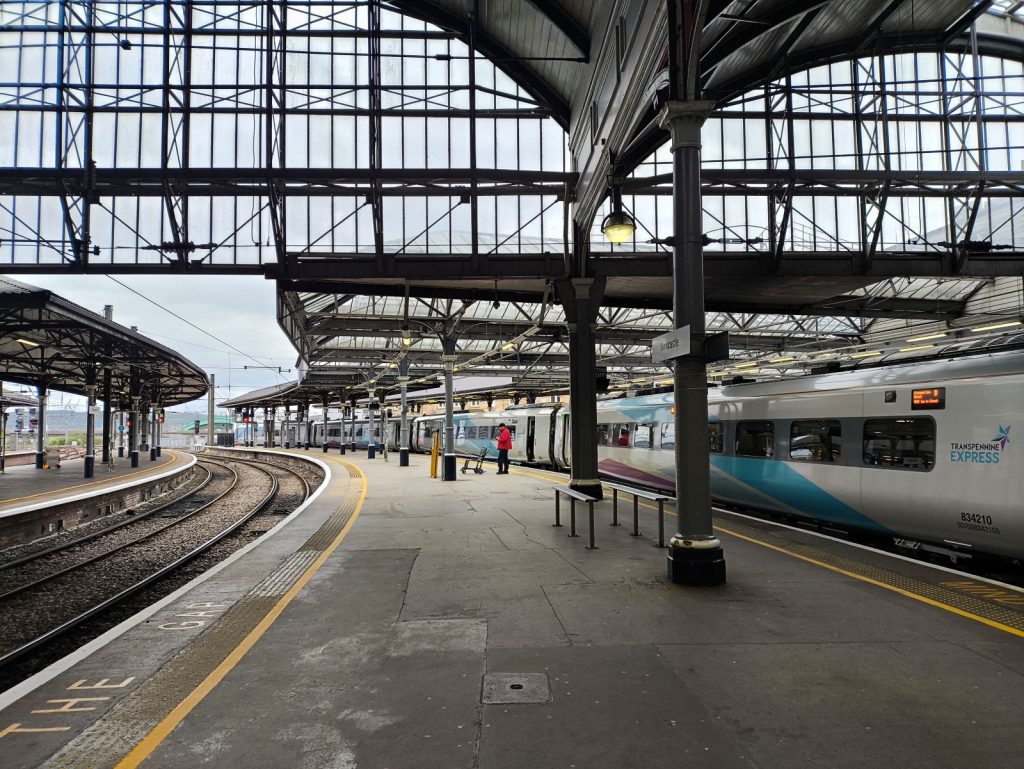 Platforms at Newcastle Central Station showing a Trans Pennine Express ready to depart.