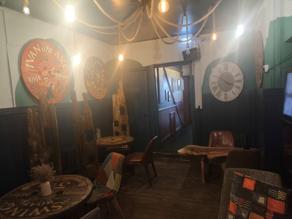 Quirky interior of the Tipsy Toad micropub on Heaton Road Newcastle showing seating and pub paraphernalia.