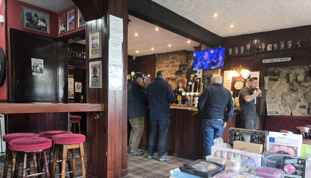 The inside of the Frog And Ferret pub in Spennymoor, County Durham with some charity raffle prizes in the foreground.