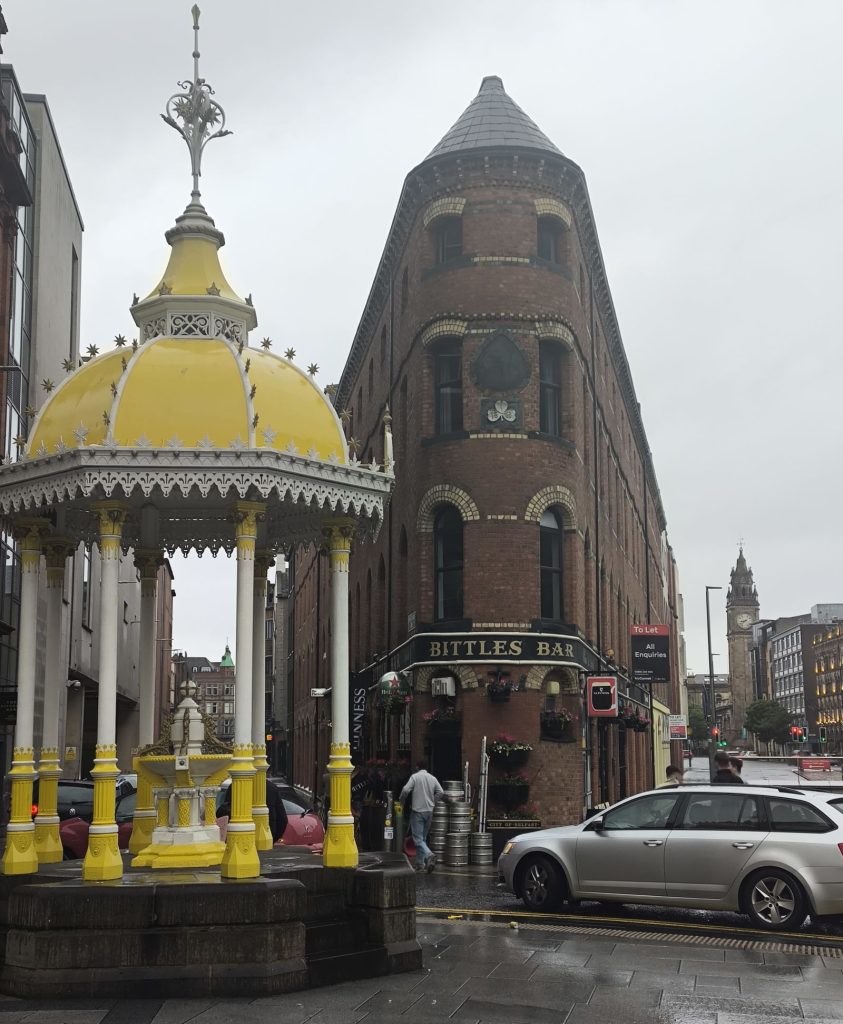 The flat iron Bittles Bar building in Belfast with the Jaffe Memorial Fountain in the foreground.