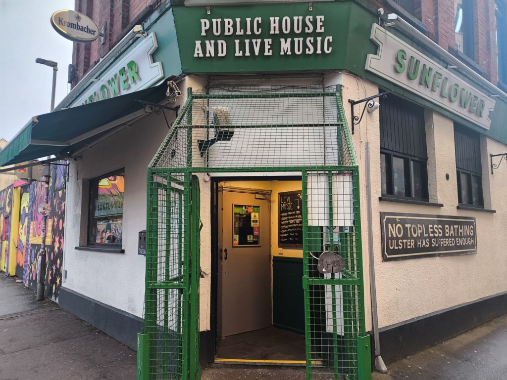 Exterior of the Sunflower Public House in Belfast showing the security cage around the door.