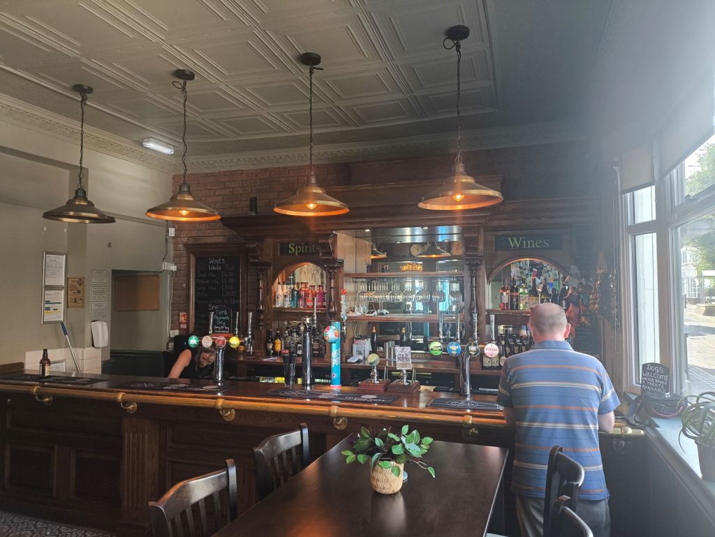 Interior of the Corner House Pub, Darlington showing the range of drinks and an ornate bar back.