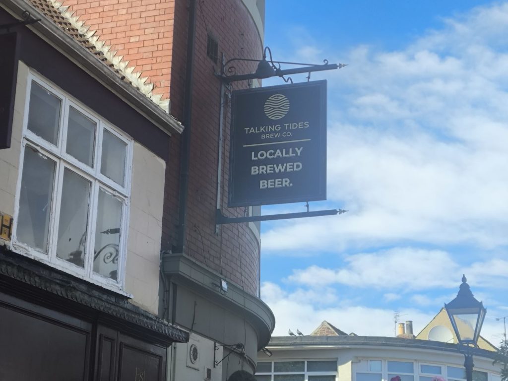 The Corner house Darlington showing the pub sign Talking Tides Brew Co and advertising "Locally Brewed Beer".