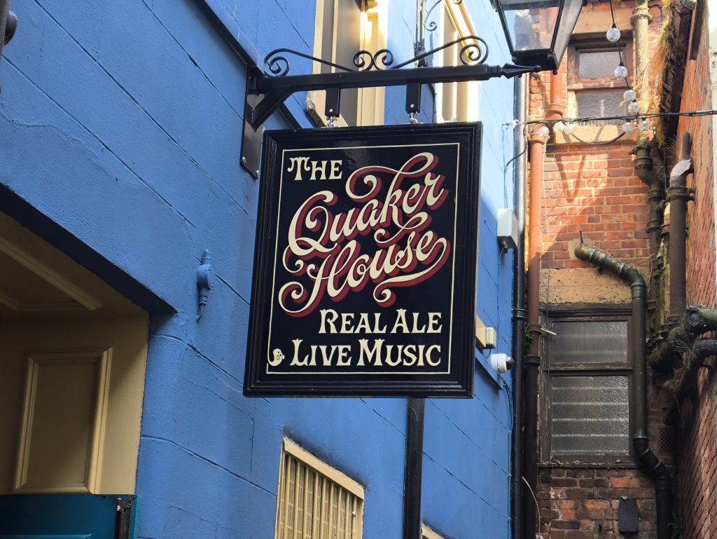 The sign for the Quaker House at Darlington with blue painted walls and advertising Real Ale and Live Music.