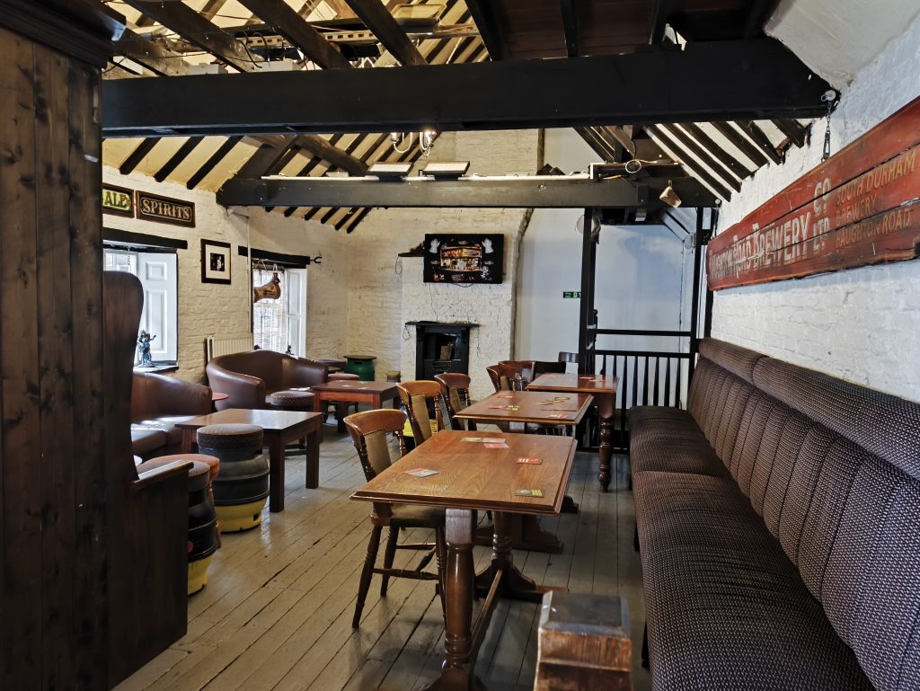 Upstairs at the Quaker House Darlington with a range of seating and exposed beams on the ceiling.