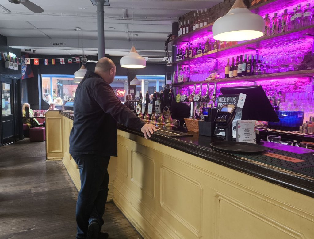The bar at the Forth Hotel on Pink Lane Newcastle with pink backlighting on the bar back.